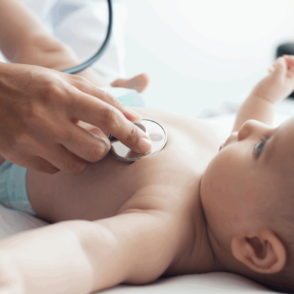 Pediatrician checking the heartbeat of a baby