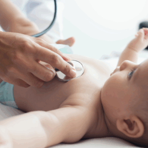 Pediatrician checking the heartbeat of a baby
