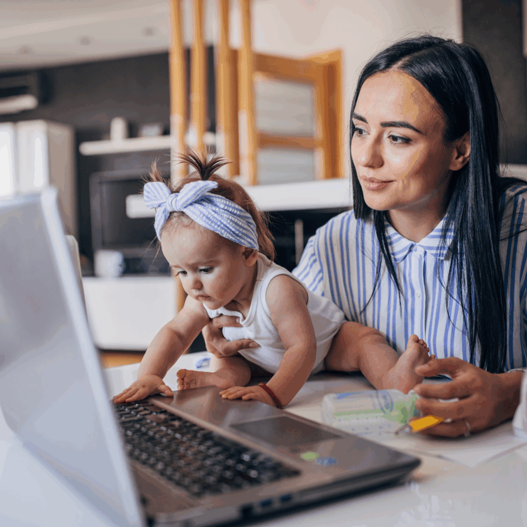 Student mom doing homework while holding baby