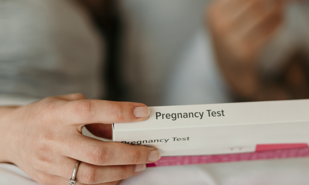 Woman holding pregnancy test box