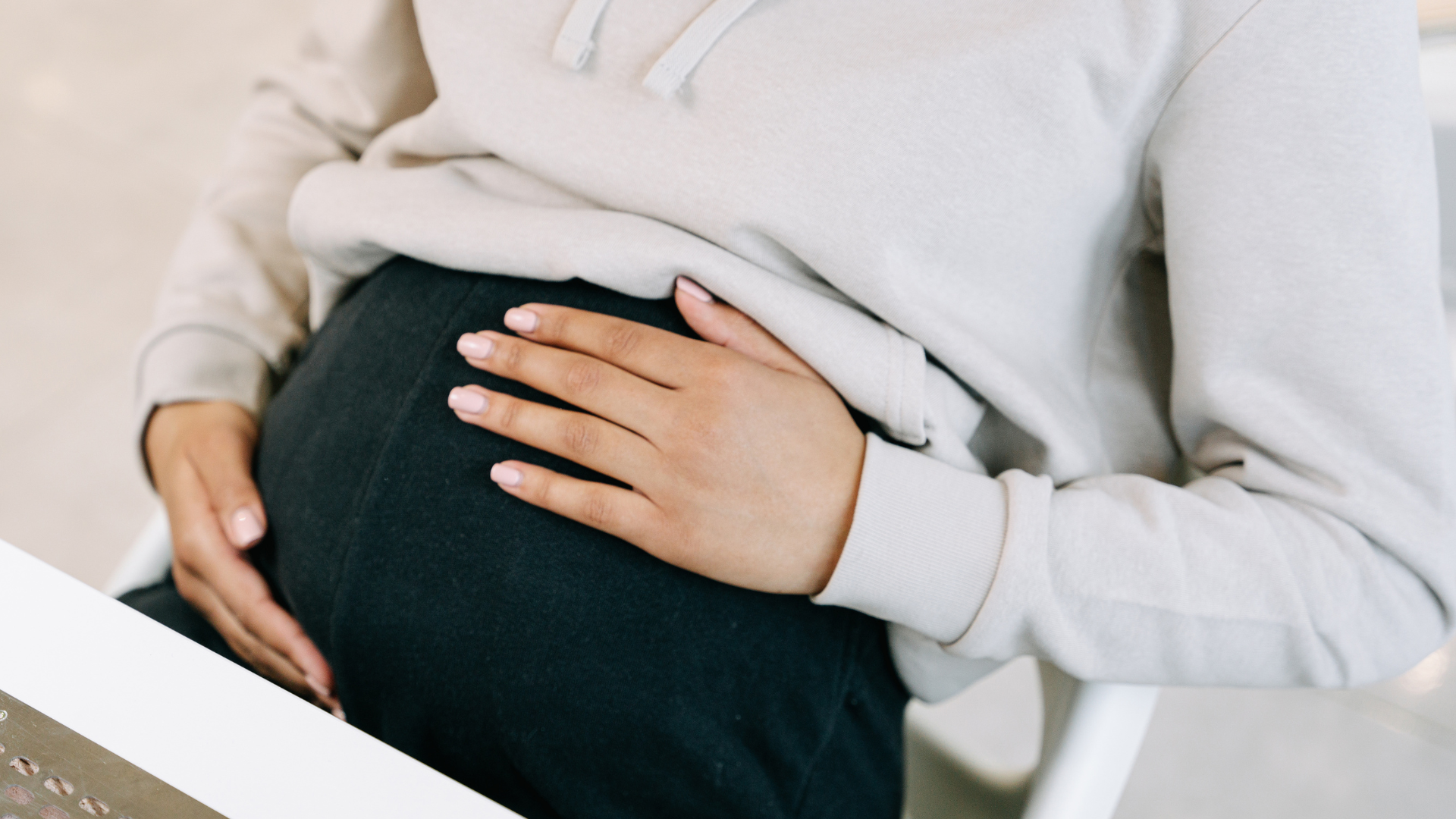 Girl holding her stomach in early pregnancy